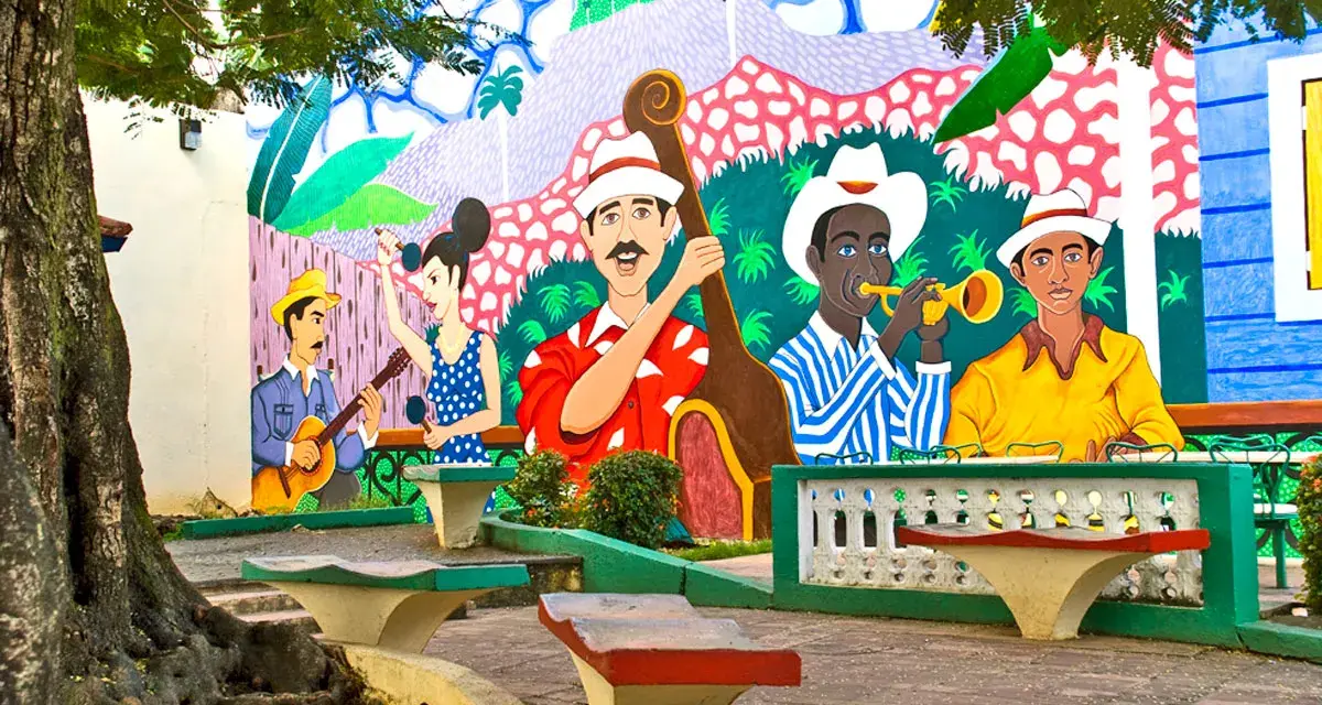 Kolorowy mural przedstawia muzyków grających na instrumentach, jakby na ulicy stolicy Kuby.