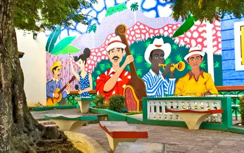 Kolorowy mural przedstawia muzyków grających na instrumentach, jakby na ulicy stolicy Kuby.