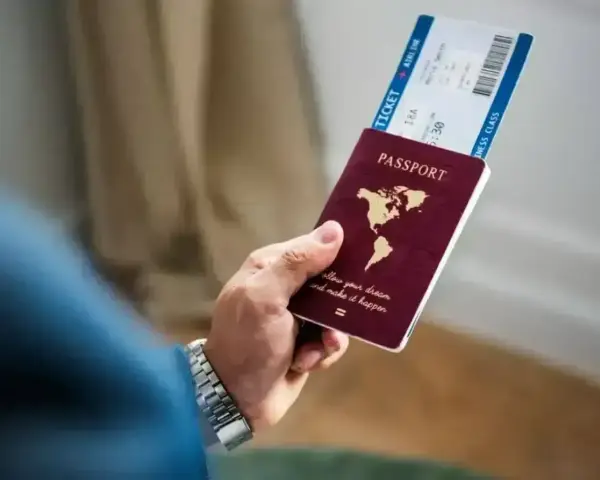 Dłoń trzyma paszport i bilet lotniczy. Planujesz podróż i zastanawiasz się, czy Cypr jest w Schengen?