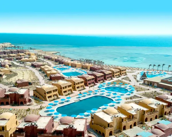 Widok z lotu ptaka na kompleks hotelowy Pickalbatros Marsa Alam z basenami i budynkami w stylu orientalnym, w tle turkusowe Morze Czerwone.