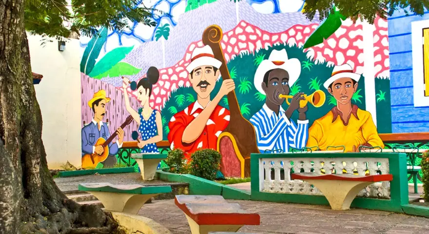 Kolorowy mural przedstawia muzyków grających na instrumentach, jakby na ulicy stolicy Kuby.